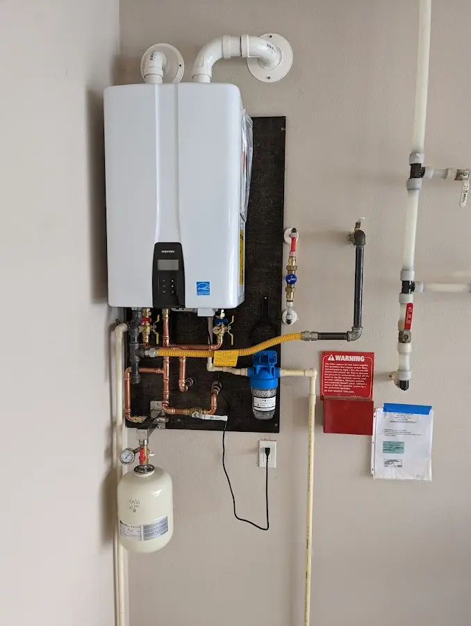 Professional plumber installing copper piping in a Country Homes home